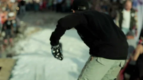 Snowboarder slides on a large railing Stock Footage 64043604