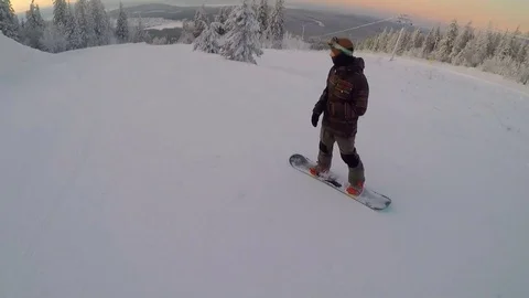 Snowboarder sliding down the mountainside Stock Footage 84219558