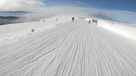 Snowboarder slopes down hill. Action camera is on snowboarder's helmet Stock Footage 120096429