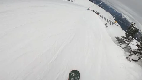 Snowboarder slopes down hill. Action camera is on snowboarder's helmet Stock Footage 144085419