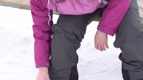 Snowboarder strapping in bindings. Stock Footage 76501700