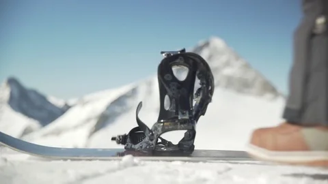 Snowboarder strapping in Stock Footage 80333343