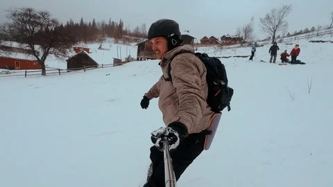 Snowboarder taking selfie while climbing mountain. snowboarder rides on the Video stock 72359546