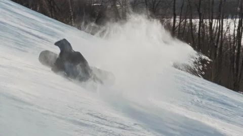 Snowboarder trying to perform a tripod trick and falls on the slope 動画素材 164044810
