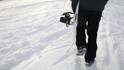 Snowboarder Walking Up on Hill for Skiing Stock Footage 103758933