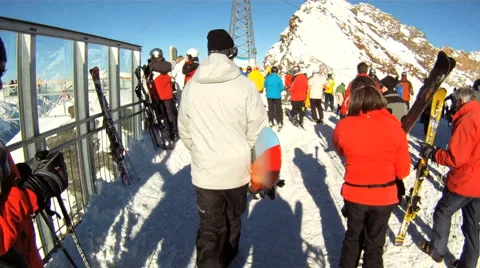 Snowboarder walking through crowd Stock Footage 3074693