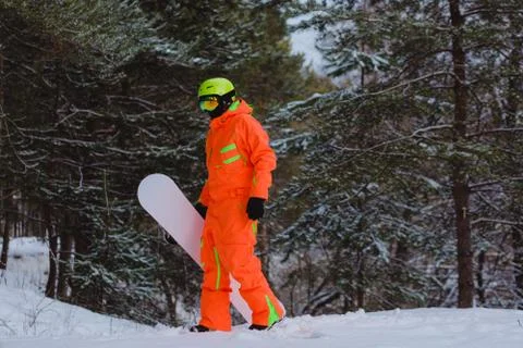 Snowboarder walking through the forest Stock Photos