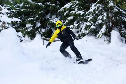 Snowboarder in a yellow jacket 스톡 사진