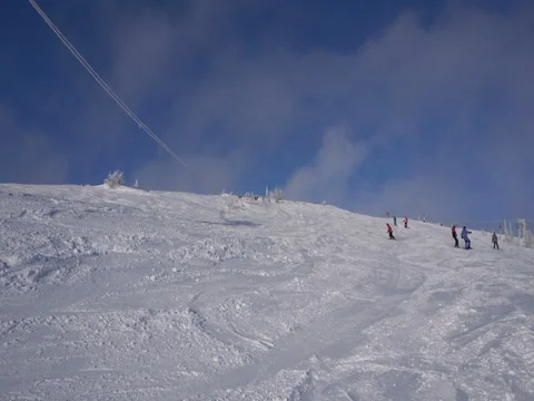 Snowboarders are going down from top of the mountain Stock Footage 71586408