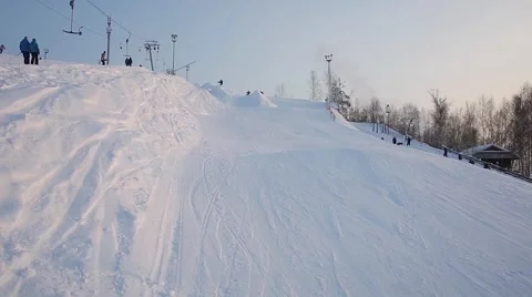 Snowboarders perform tricks on the slopes Stock Footage 59723444