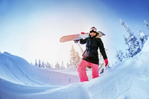 Snowboarders posing on blue sky backdrop in mountains Stock Photos