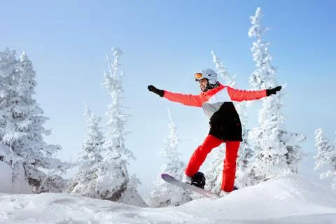 Snowboarders posing on blue sky backdrop in mountains 스톡 사진