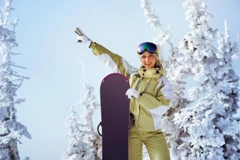 Snowboarders posing on blue sky backdrop in mountains Stock Photos
