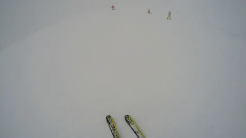 Snowboarders try to scrape down the hill during blizzard in mountains Stock Footage 108588505