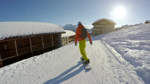 Snowboarding back to a hotel Stock Footage 66957052