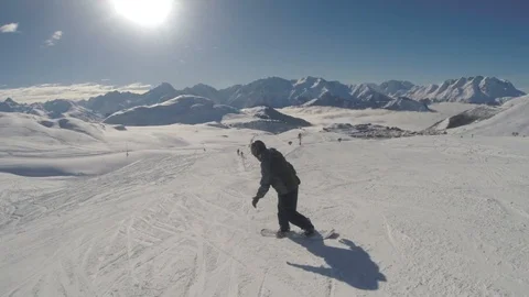 Snowboarding down a piste in the Alps Stock Footage 86482838