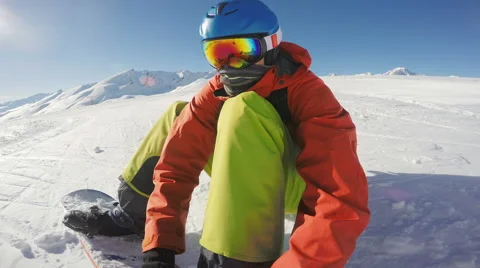Snowboarding putting a board on Stock Footage 66958976