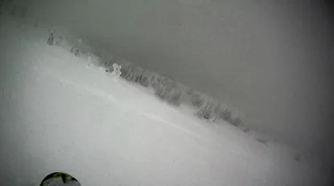 Snowboarding a slope in blizzard Stock Footage 22475937