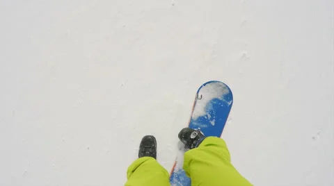 Snowboarding trying to walk with the board on Stock Footage 66976748