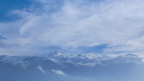 Snowbound mountain ridge under dense cloudy sky Stock Footage 331997136
