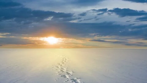Snowbound plain with human track at the sunset, winter seasonal time lapse scene Stock Footage 165349280