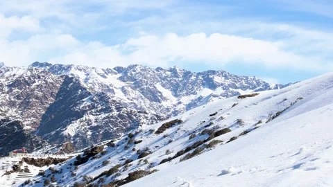 Snowcap mountain range covered with fresh snow and bright blue sky at morning 動画素材 305135117