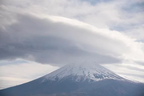 Snowcapped and cloud hat phenomena against the most beautiful volcano of the  Stock Photos
