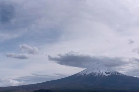 Snowcapped and cloud hat phenomena against the most beautiful volcano of the  Stock Photos