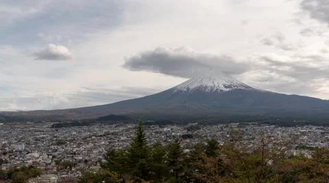 Snowcapped and cloud hat phenomena against the most beautiful volcano of the  Stock Photos