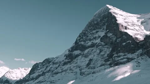 Snowcapped Mountain Peak Eiger North Face in a Sunny Winter Day Stock Footage 345786358