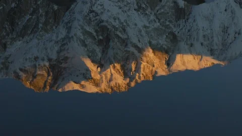 Snowcapped Mountain Reflection in Rippling Lake Stock Footage 124555069