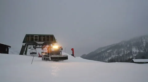Snowcat in action at evening Stock Footage 62990398