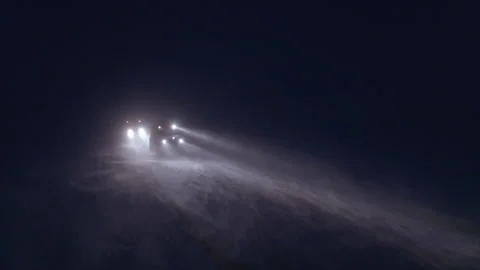 Snowcat driving through a heavy blizzard at night Stock Footage 337037826