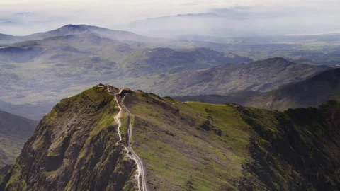 Snowdon Mountain Railway train ascending the peak in Wales Stock Footage 336810367
