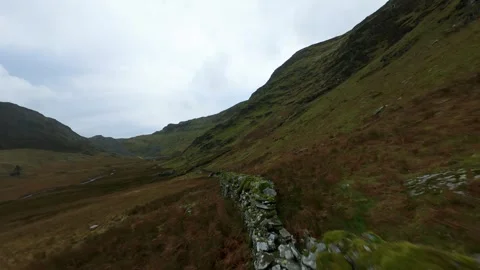 Snowdonia FPV: Dynamic Flight Over Dry Stone Wall Stock Footage 321823259