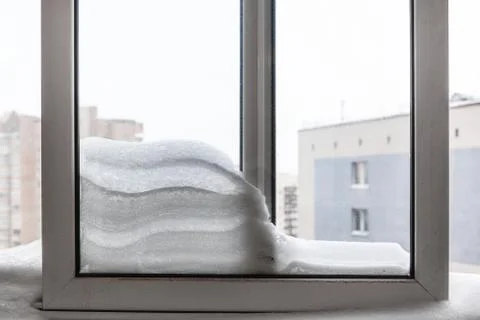Snowdrift between frames on balcony in winter Stock Photos
