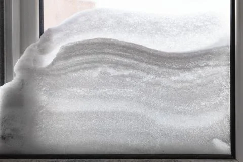 Snowdrift between two windowpanes Stock Photos