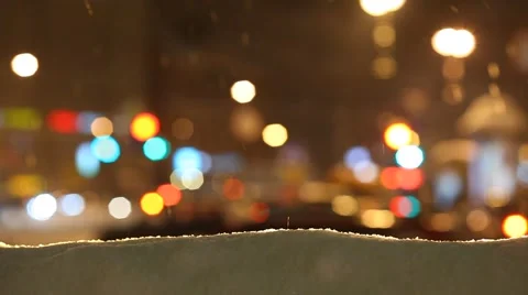 Snowdrift edge and falling snow against blurred city traffic lights Stock Footage 66201765