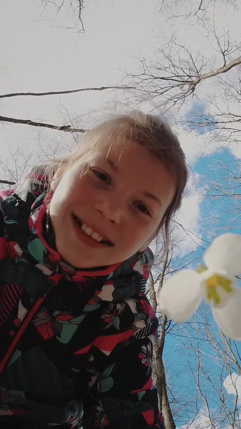 Snowdrops in the forest. spring forest. flowering snowdrops. teenage girl Stock Footage 312800859