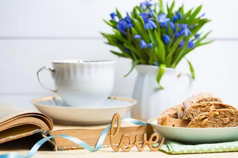 Snowdrops in a vase on a table on a white background. Stock Photos