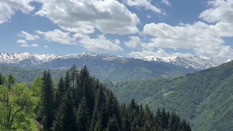 Snow‑dusted ridges of the Chhalhal Range frame the breathtaking alpine Stock Footage 311381078