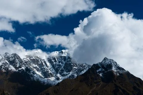 Snowed up mountain range and clouds in himalayas Stock Photos