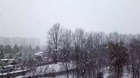 Snowfall against backdrop of city landscape. Stock Footage 255386997