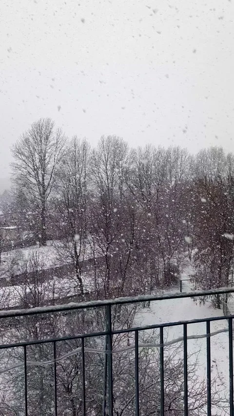 Snowfall against backdrop of city landscape. Stock Footage 255681153