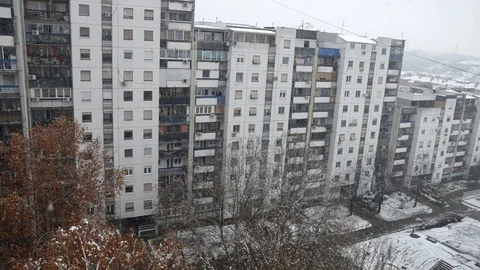 Snowfall and a building Stock Footage 83159624