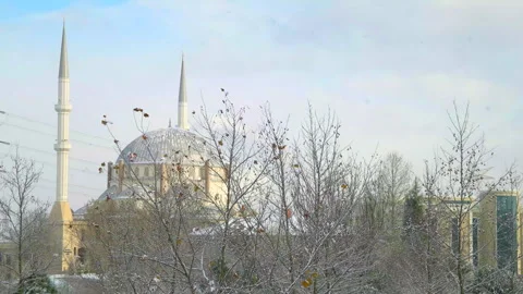 Snowfall And Mosque in a big city Video stock 242476256