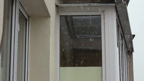 Snowfall on background of the balcony of a multistory building Stock Footage 123765775
