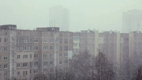 Snowfall on background of the city and trees with bird nests Stock Footage 123765818