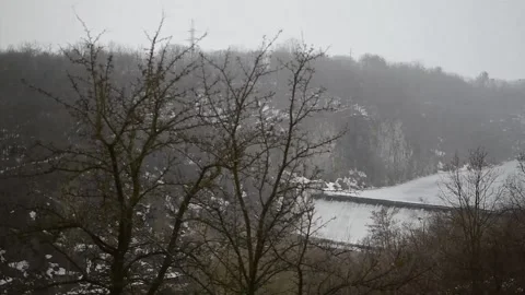 Snowfall on background of winter landscape with river Stock Footage 149891474