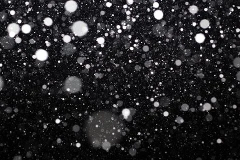 Snowfall on black background Stock Photos